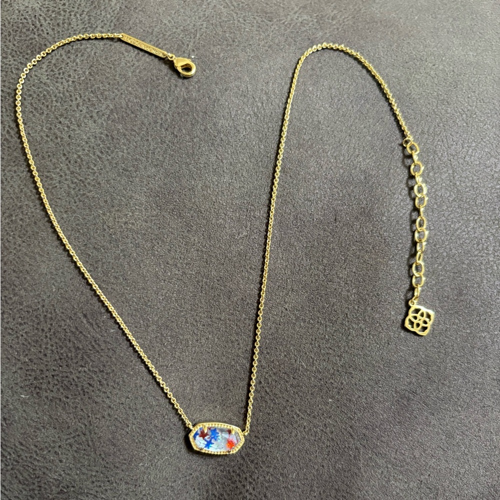 Kendra Scott gold necklace with red, white, and blue stars pendant